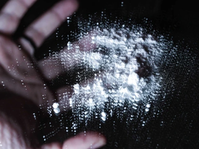 White opioid powder on glass