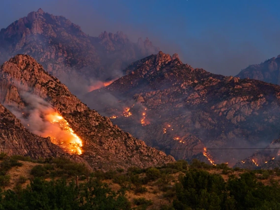 wildfires burning in a desert mountain range