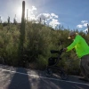 Taylor Moore walking up Tumamoc Hill as the sun beats down overhead