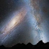 In this artist's illustration of Earth's night sky in 3.75 billion years, Andromeda fills the field of view and begins to distort the Milky Way with tidal pull.